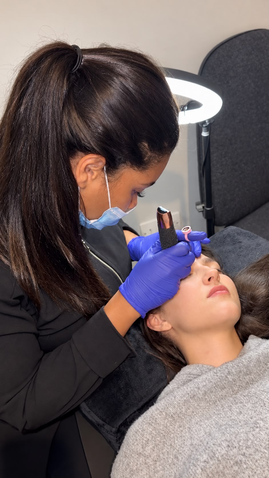 Alexsia carefully performing a brow treatment